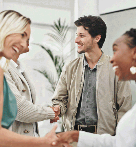 Group of business people shaking hands at a work event